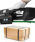Portable Electric Strapping Machine Offering A Smooth Operator Design For Pp Pet Straps Rechargeable Handheld Baler in use on green strap with box.