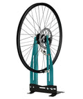 Pro Grade Bicycle Wheel Truing Stand With Adjustable Width And Dual 360 Degree Rotating Adjustments, holding a bike wheel.