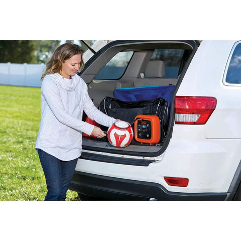 Woman using 12V DC Multipurpose Inflator With Digital Gauge, High-Volume For Air Mattresses And Rafts, in car trunk