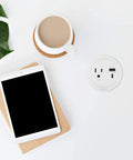 Round Furniture Power Center With USB Ports 1 Outlet USB Type A And USB C 6 Foot Cord White Low Profile Mount on table