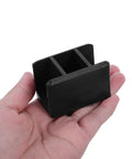 Hand holding Heavy-Duty Black Right Angle Furniture Brackets Set 10 Pack for Steel Frame Shelves, showcasing bracket size and durability.