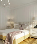 European Modern Minimalist Country Stripe Wallpaper Roll For Living Room Bedroom And TV Backdrop In Cream White Non Woven Eco Friendly Material With Rich Texture Subtle Gloss And Enhanced Depth For A Cozy Home Vibe shown in a bedroom setting.
