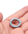 Person holding Upgrade Kit With 22 Piece Sealed Bearing Kit In Blue For One Eighth And One Seventh RC Cars Fits Kraton Typhon Senton Talion