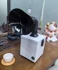Desktop Soldering Fume Extractor Featuring Dual Stage Carbon Filtration And Extendable Hose on a wooden table with flexible hose and switch.