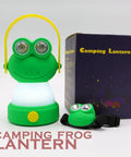 Green frog-shaped LED camping lantern and headlamp set next to packaging. Owl Themed Kid Friendly LED Lantern And Headlamp Set Battery Powered Lit Night Light For Emergency And Camping Lightweight Tent Lamp For Children Perfect For Hurricanes And Backyard Adventures.