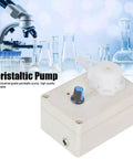 Peristaltic Liquid Dosing Pump For Lab And Aquarium Use 110 To 240 Volts, 50 And 60 Hz, 4 Watts, with laboratory glassware in background