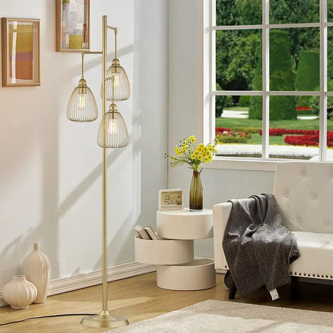 Farmhouse Style Teardrop Cage Floor Lamp With Three Light Heads by a window in a bright living room.