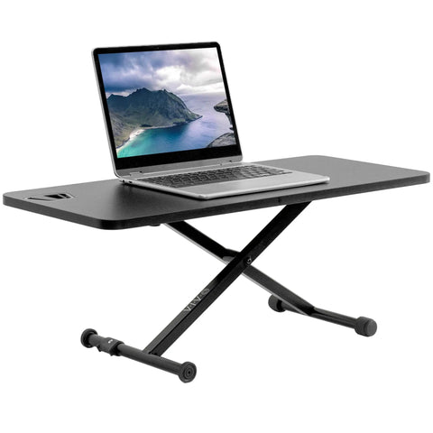 Black 28 Inch Standing Desk Converter Sit To Stand Monitor Riser With Scissor Lift Height Adjustment, laptop displayed on top