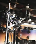 Chrome Cymbal Clamp With Adjustable Boom Arm Featuring Fastclamp System And Quick Tilter Fits Standard Drum Pipes in use on stage.