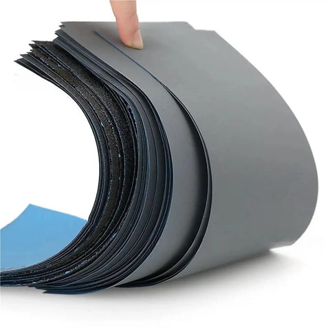 Get Your Hands On 50 Pieces Of Premium Wet Dry Silicon Carbide Sandpaper Sheets With Assorted Grits Perfect For Woodworking And Auto Detailing Projects That Need Serious Power And Smooth Finish Results Today, showing stacked sheets.