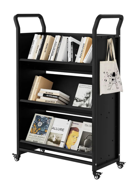 V Shaped Metal Rolling Book Cart With Three Tier Shelves, Side Hooks, Lockable Wheels displaying books and a bag, black.