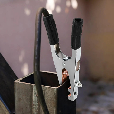 Heavy Duty Copper Welding Ground Clamp With Strong Load Bearing Iron Construction Perfect For Easy Use In Serious Welding Scenarios And Reliable Performance attached to a metal workpiece.