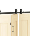 Four Door Bi-Fold Sliding Barn Door Hardware Kit in Rustic Black installed on light wood doors with rollers and hinges visible