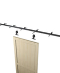 6 Ft Sliding Barn Door Hardware Kit with Top Mounted Track for Aluminum Glass Doors, Matte Black, shown above a wooden door