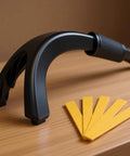 Black ergonomic Rubber Push Stick With Hold Down Clamp Set beside yellow wood guides on a table