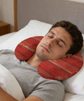 Man sleeping with U Shape Memory Foam Travel Pillow With Red Wood Grain Finish For Airplane Rides Car Trips Office Or Home Ergonomic Neck Support Portable Comfy Rest For A Restful Sleep Anywhere in bed.