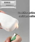 Tough As Nails Waterproof Sealant Clay For Quick Fix Wall And Drain Patching White Two Pack shown in hand with flame for heat resistance test.