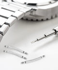 Ten Piece Curved Spring Bar Watch Band Pins Fits 30mm Straps With 1.5mm Diameter crafted from stainless steel with a tool and watch bracelet.