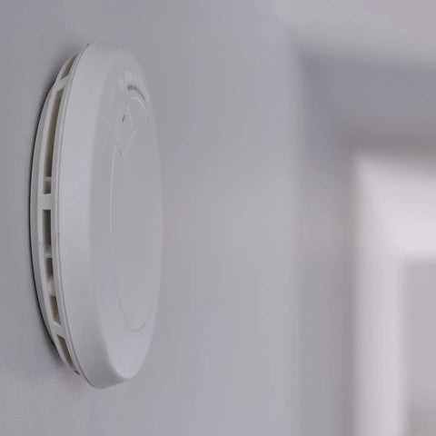 Ultra Slim Photoelectric Smoke Alarm With 10-Year Sealed Battery, Easy Twist Lock Mounting, Tamper Resistant Design, White PR710 on wall