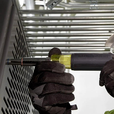 Gloved hand using Six In One Nut Driver Set Built Tough With Heavy Duty Hollow Shaft for long bolts on metal panel.