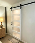Heavy Duty Sliding Frosted Glass Barn Door With Five Panel Design And Full Roller Track Hardware Ready To Roll Smooth Glide System For Closet Bedroom Or Bathroom Modern Privacy Partition No Sweat Setup in bedroom setting.