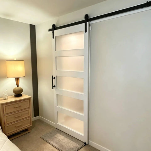 Heavy Duty Sliding Frosted Glass Barn Door With Five Panel Design And Full Roller Track Hardware Ready To Roll Smooth Glide System For Closet Bedroom Or Bathroom Modern Privacy Partition No Sweat Setup in bedroom setting.