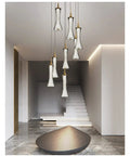 Modern Black Creative Pendant Lamp Pretty Waist LED Light for Duplex Living Room Staircase Loft Restaurant hanging in upscale setting.