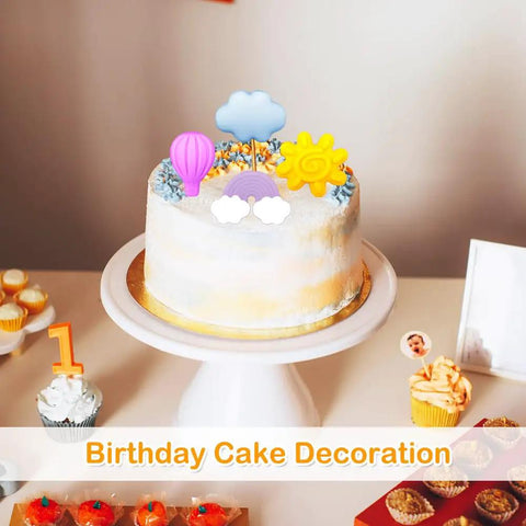 White cake with sun, cloud, and hot air balloon shapes from 2 Pack Silicone Chocolate Molds With 12 Cavities Sun Cloud Rainbow Hot Air Balloon Shapes