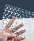 Clear Cabinet Door Bumpers Kit, 61 Pieces Self Adhesive Soft Rubber Pads In Four Sizes, held in hand showing shapes