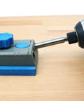 Close-up of pocket hole jig system with One Quarter Inch Hex Shank Pocket Hole Drill Bit With Depth Stop Collar installed, on wood surface.