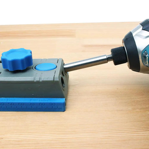 Close-up of pocket hole jig system with One Quarter Inch Hex Shank Pocket Hole Drill Bit With Depth Stop Collar installed, on wood surface.