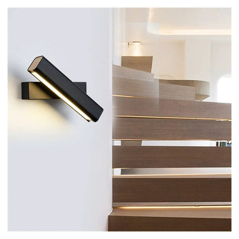Elevate Your Home Vibe With This Sleek Black Metal Swivel Wall Sconce Led Lighting For Bedroom Living Room And Hallways Rustproof Adjustable Accent Lamp mounted on a white wall above wooden stairs.