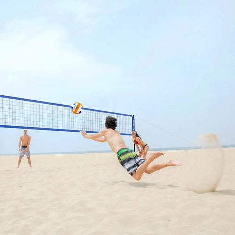 People playing beach volleyball with Heavy Duty Outdoor Volleyball Net Set With Anti Sag Design And Adjustable Aluminum Poles