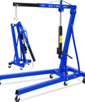 Badass 2 Ton Hydraulic Engine Hoist With Telescopic Boom And Six Heavy Duty Swivel Casters For Easy Motor Swaps and Heavy Shop Moving Projects In Your Dream Garage showing blue hydraulic hoist with foldable design.