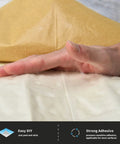 Hand peeling adhesive backing of Black Faux Brick Peel And Stick Wall Panels for easy DIY install and strong adhesion on surfaces.