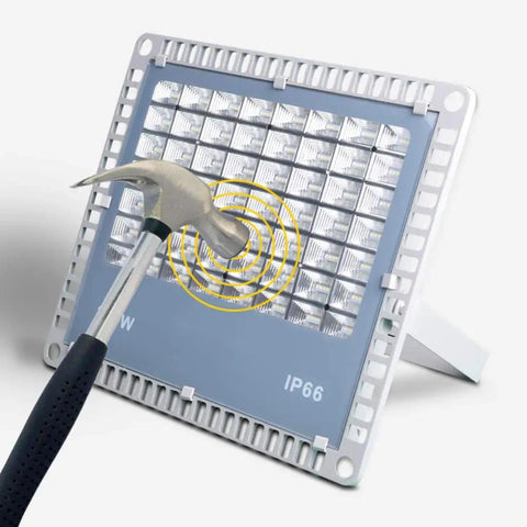 Heavy Duty 200W LED Flood Light With Tough As Nails Waterproof Housing For Yard Billboard And Deck Super Bright Outdoor Spot Lighting No Cap Badass Performance Rock Solid Build Hella Durable being tested with a hammer.
