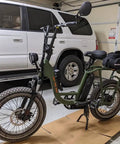 Electric bike with Syvrac Aluminum Suspension Fork for 20 inch fat bikes and snow mountain ebikes, parked in a garage.