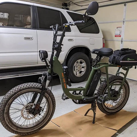 Electric bike with Syvrac Aluminum Suspension Fork for 20 inch fat bikes and snow mountain ebikes, parked in a garage.