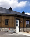 Legit Reactive Water Based Wood Stain With A Slick Reclaimed Vibe Weathered Tan Tones Hit Different On Any Surface Voc Free Solid Formula For Interior Or Exterior Jobs In 55 Gallon Drum used on a rustic wooden building with stone foundation.