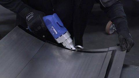 Heavy Duty Electric Metal Cutting Shears With Rotating Jaws Variable Speed 0 To 2500 Rpm Rips Right Through 18 Gauge Steel Like Butter For Any Quick Fabrication Job in action, cutting curved steel sheet.
