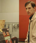 Man in shop setting from Cat Sick Blues Blu Ray Region Free Edition A Dark Gripping Gritty Indie Drama About Grief After A Cat Dies