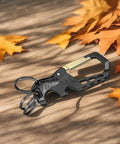Heavy Duty Metal Keychain Set With Carabiner Clip, Bottle Opener And Three Key Rings on wooden surface with autumn leaves