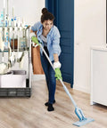 Heavy Duty Mobile Housekeeping Cart With Slick Rolling Wheels Built In Storage Shelves And Solid Broom Mop Holder in use by a woman cleaning.