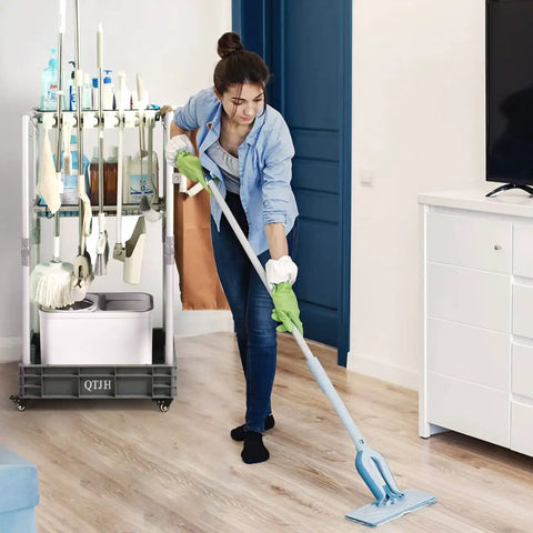 Heavy Duty Mobile Housekeeping Cart With Slick Rolling Wheels Built In Storage Shelves And Solid Broom Mop Holder in use by a woman cleaning.