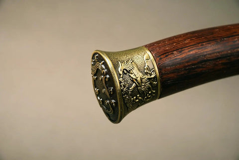 Close-up of the rosewood handle with phoenix motif on the Folded Steel Dao Sword With Phoenix Motif, Handmade High Carbon Blade With 32,768 Layered Steel
