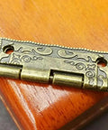 Legit Mini Brass Cabinet Hinge For Wooden Furniture Drawer Connector Vintage Antique Hardware with ornate design on wooden surface.