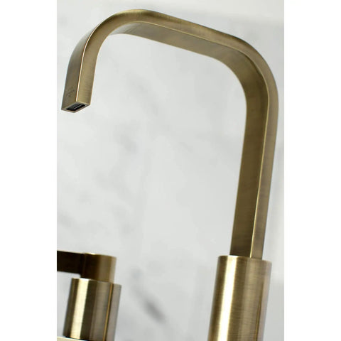 Antique Brass Widespread Bathroom Faucet With Drip Free Ceramic Disc Cartridge Deck Mount Eight To Sixteen Inch Three Hole Installation One Point Two GPM Flow At Sixty Psi One Half Inch IPS Connection Classic Modern Blend shown close-up