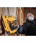 Person using Heavy Duty Electric 5 In 1 Multi Tacker for DIY projects on wooden surface indoors.