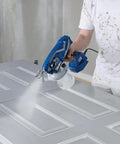 Professional Corded Airless Paint Sprayer With Triax Triple Piston Pump And Smart Control Dial for smooth paint application on door.
