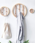 Solid Wood Wall Mount Coat Hooks For Everyday Gear Heavy Duty Nordic Style Round Cloak Pegs. Three wall hooks displaying a jacket and bag.